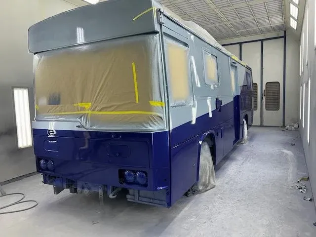 A coach masked and resprayed navy in the 18-metre booth