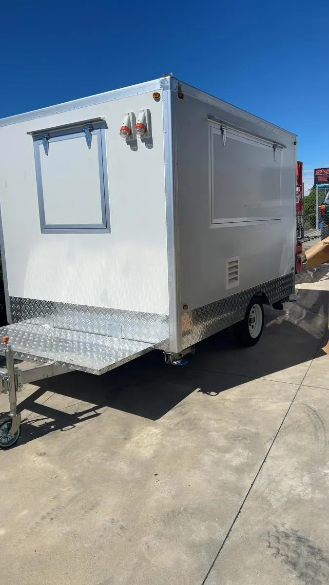 A food trailer as a bare white shell before fit-out and signage