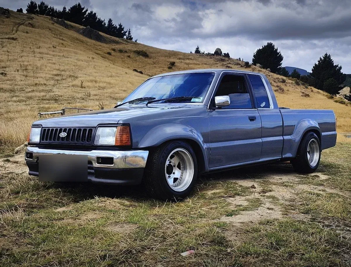 The same Ford Courier ute restored in metallic grey