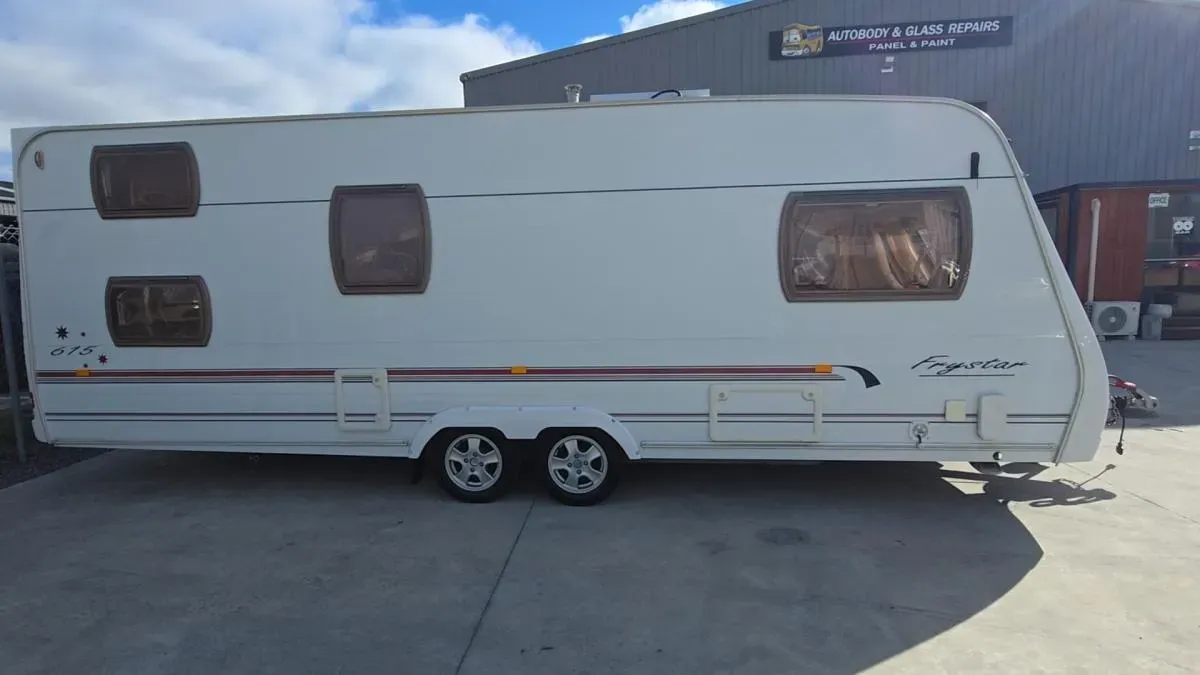 A caravan outside the Autobody & Glass Repairs workshop