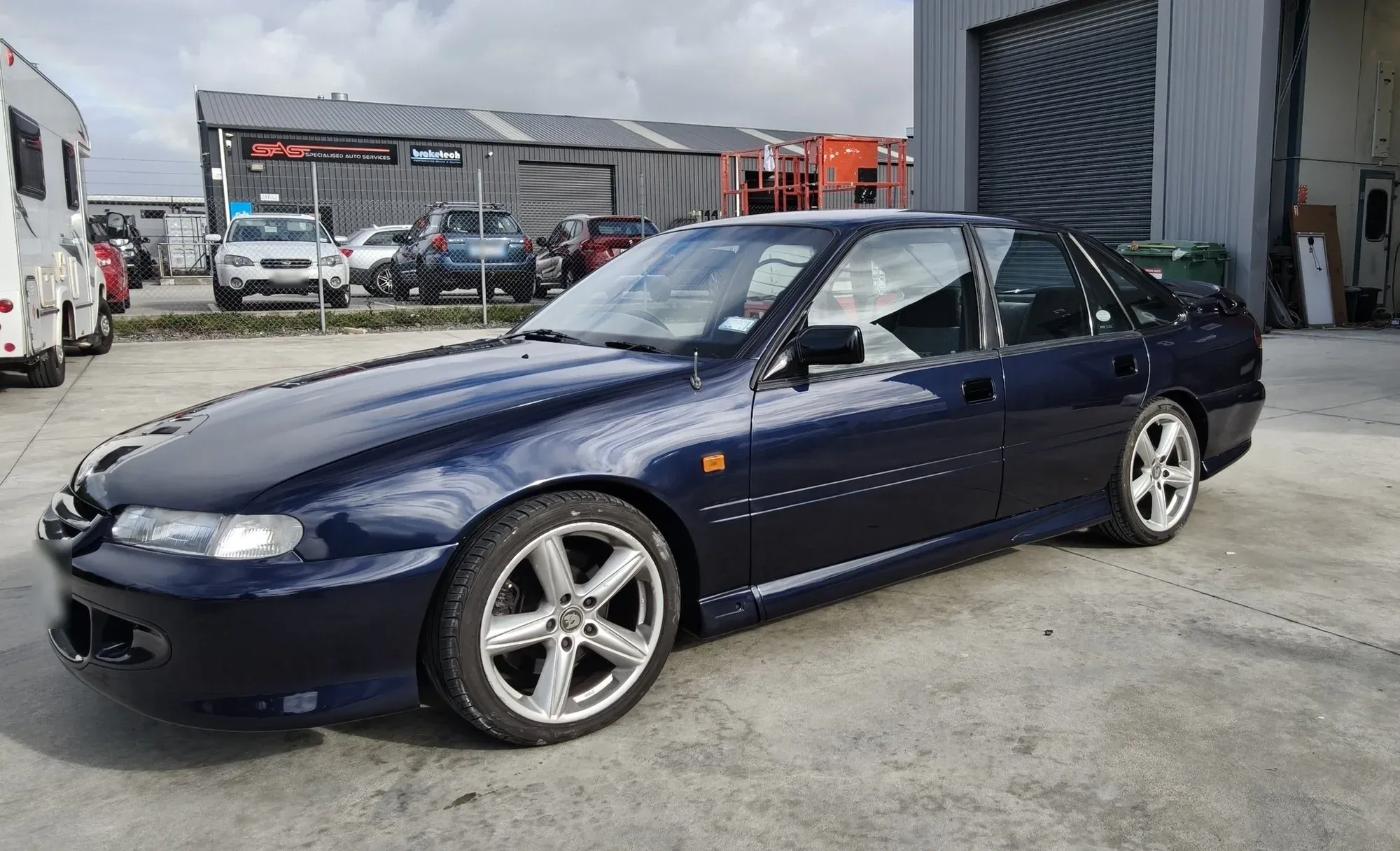 The same Holden Commodore finished in deep navy metallic