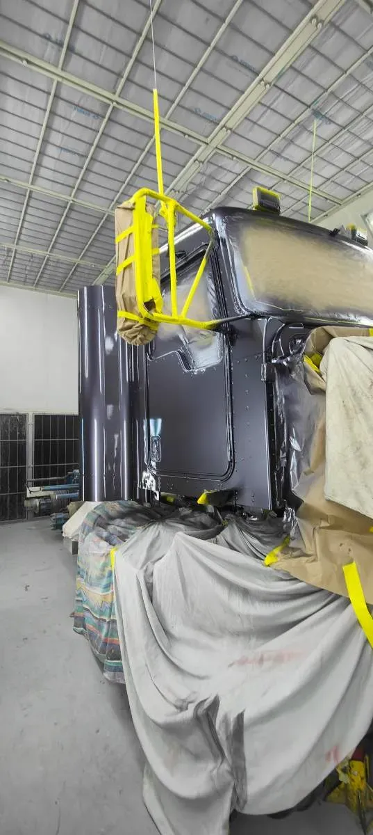 A truck cab freshly painted in the spray booth