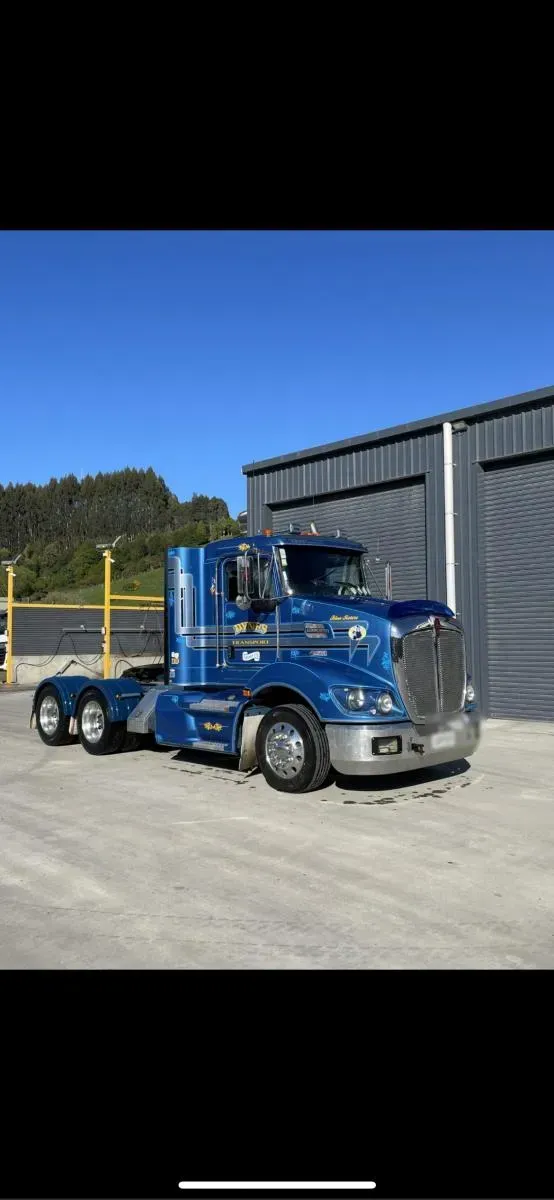 A Dynes Transport Kenworth truck in blue and gold livery