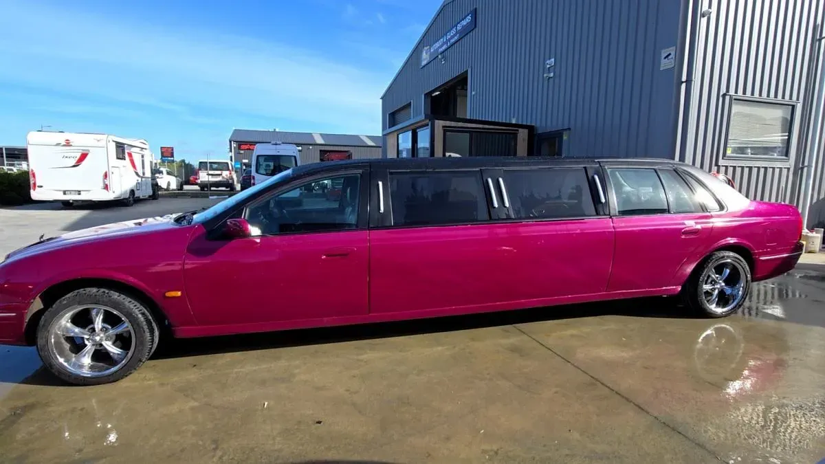 The same stretch limousine finished in gloss magenta