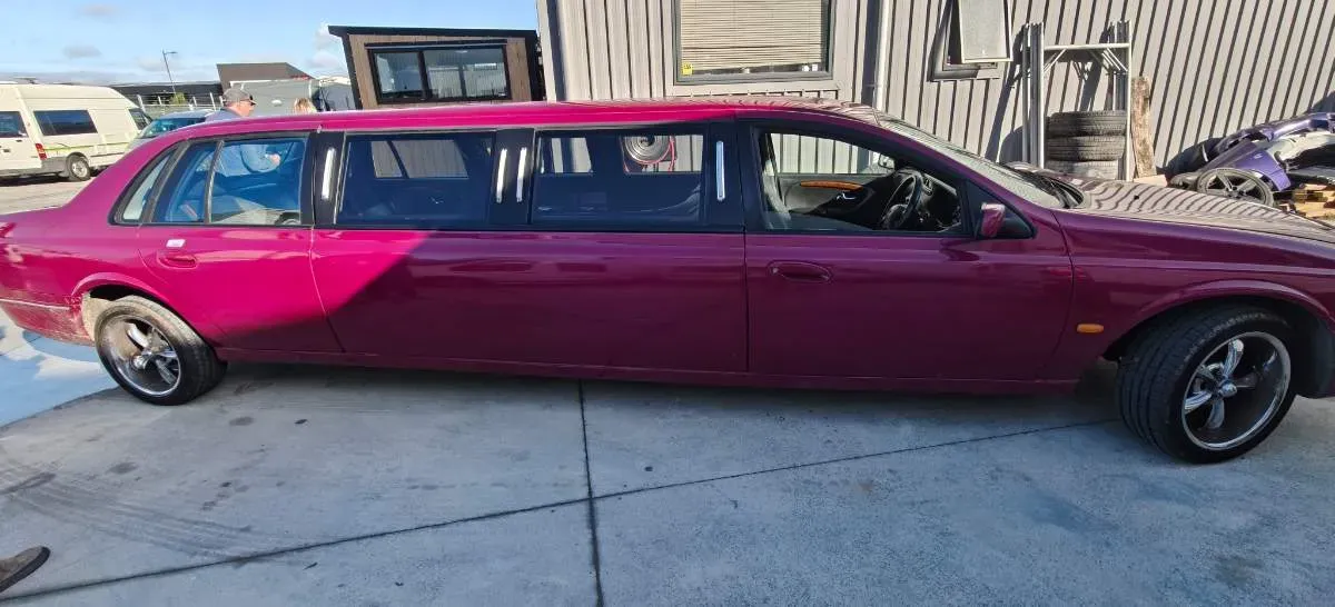 A stretch limousine in faded two-tone paint before its respray
