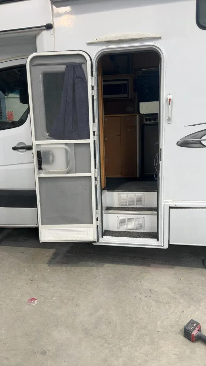 The same motorhome doorway rebuilt with a new door, frame and steps