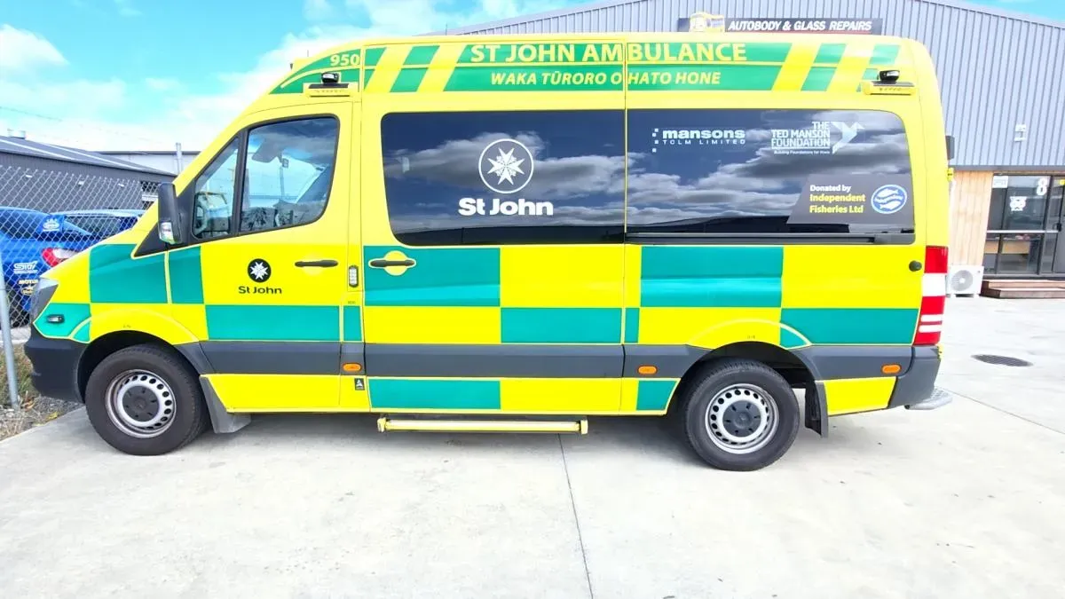 A St John ambulance outside the Autobody & Glass Repairs workshop