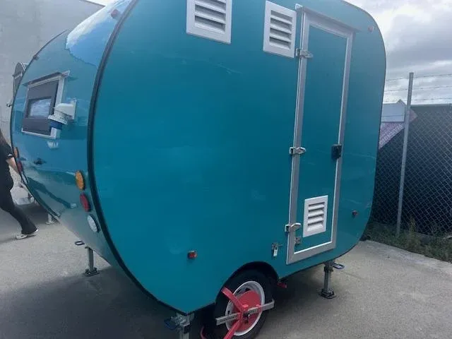 The same teardrop trailer finished in deep teal