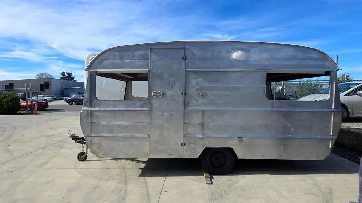 A vintage caravan stripped back to bare metal