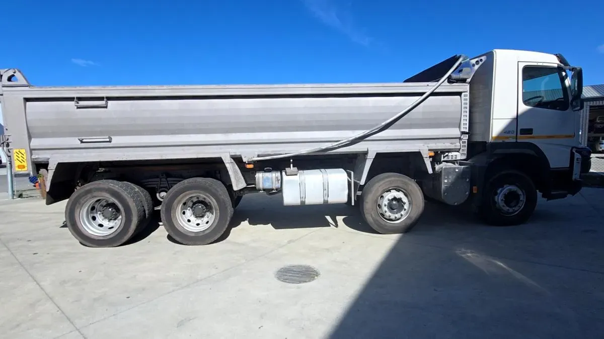 A Volvo tipper truck outside the workshop